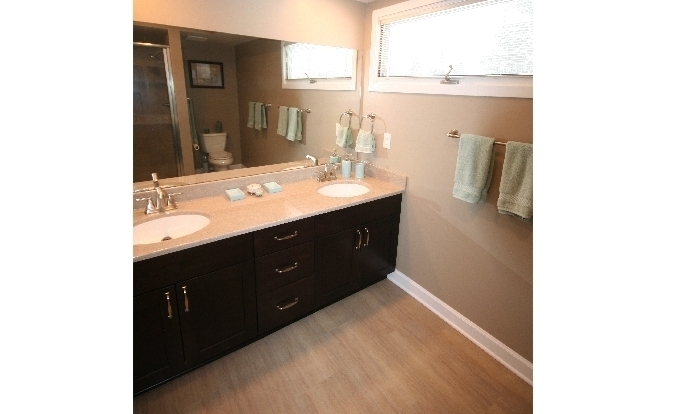 This bathroom located in Ann Arbor uses Cardinal,DalTile,Delta,Onyx,Sherwin Williams,Showplace Cabinets,Top Knobs